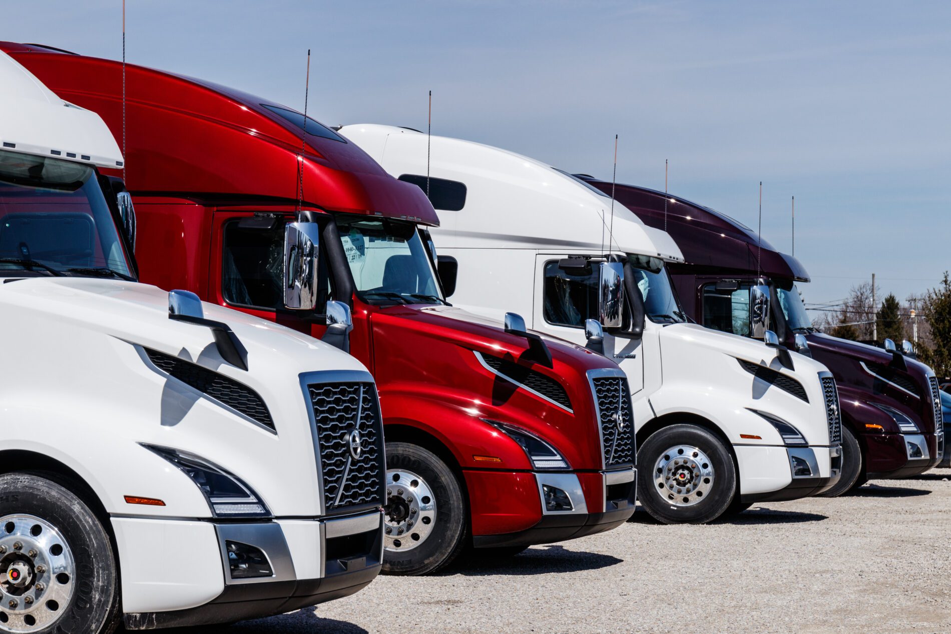 Muncie - Circa March 2019: Colorful Volvo Semi Tractor Trailer Trucks Lined up for Sale. Volvo is one of the largest truck manufacturers II Muncie - Circa March 2019: Colorful Volvo Semi Tractor Trailer Trucks Lined up for Sale. Volvo is one of the largest truck manufacturers II